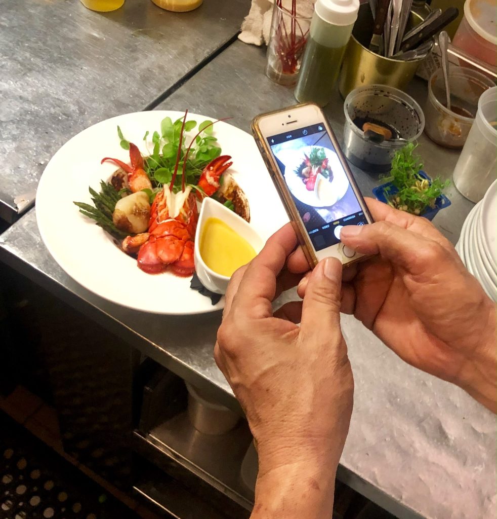 Chef Kfir plating a lobster dish
