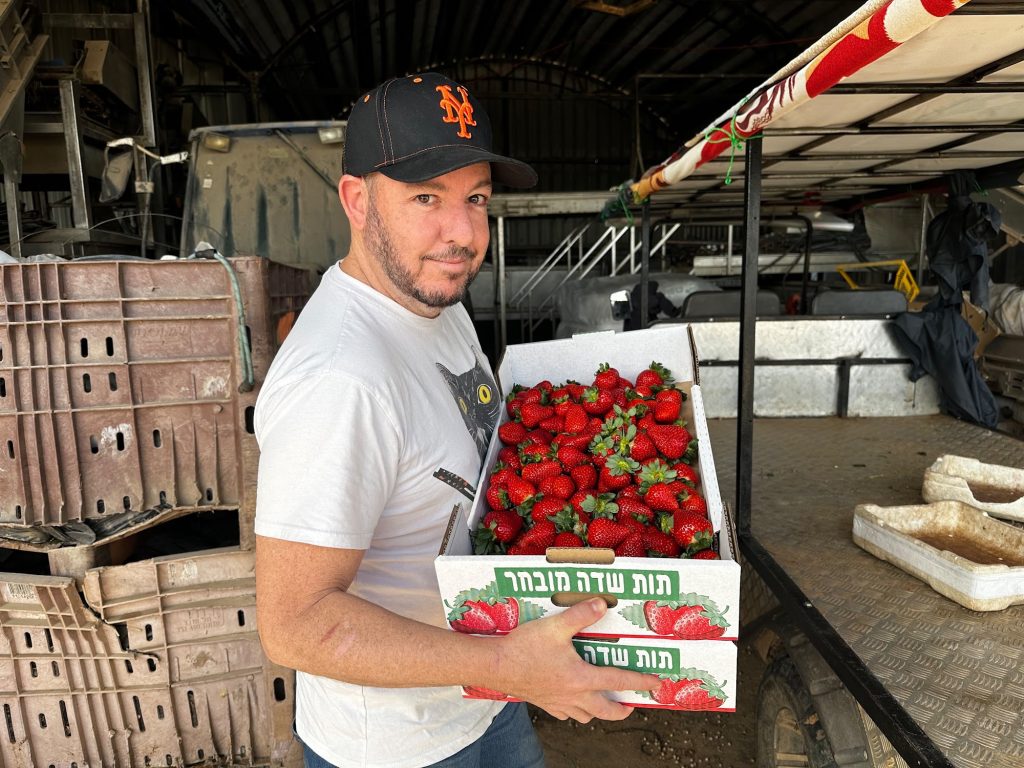 Chef Kfir at the market with fresh strawberries