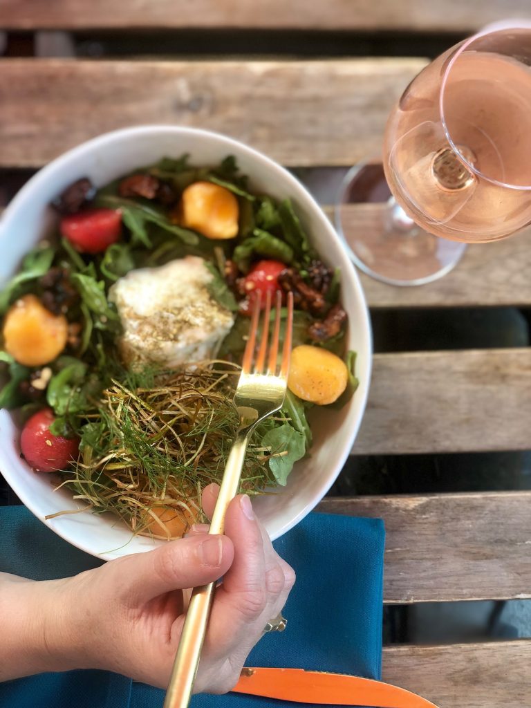 Seasonal salad with a glass of rose wine